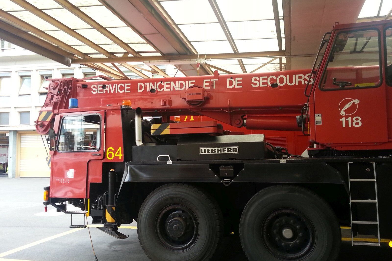 Totem Advenuture A red fire truck with a crane, with the inscription 