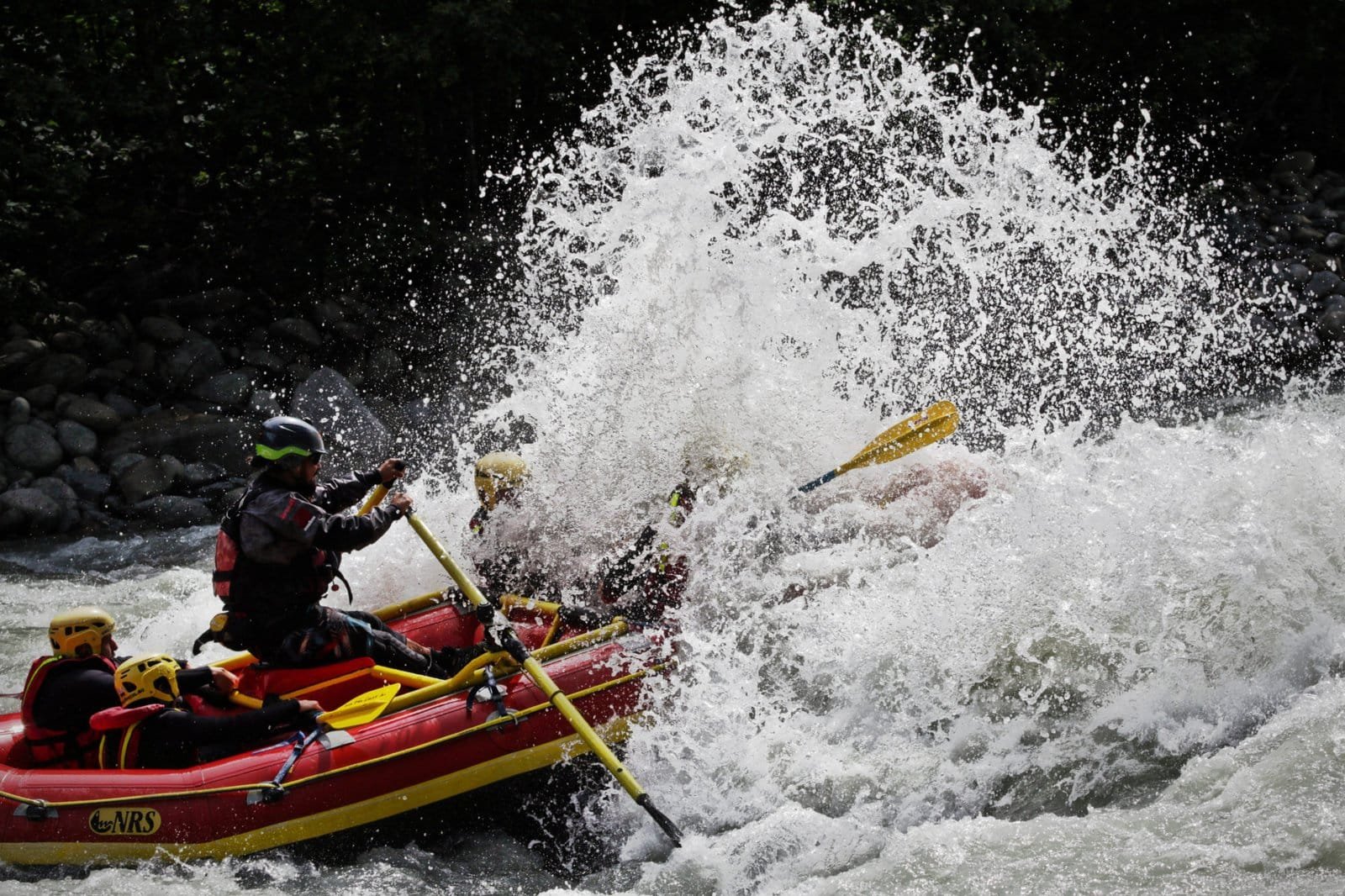Totem Advenuture A group of people enjoy rafting in the Aosta Valley, surrounded by rushing waves, as they embark on exciting outdoor experiences in the region. Rafting Kayaking Paragliding Canyoning Aosta Valley
